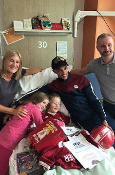 Alexander-Arnold gifted presents to a child in a hospital.