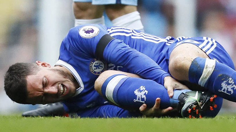 Eden Hazard holding his injured leg